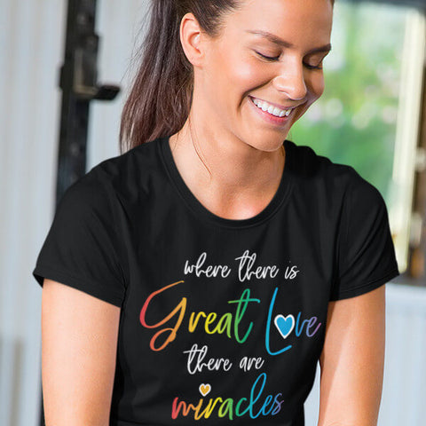 Smiling Woman Wearing Black "Where There Is Great Love, There Are Miracles" T-Shirt